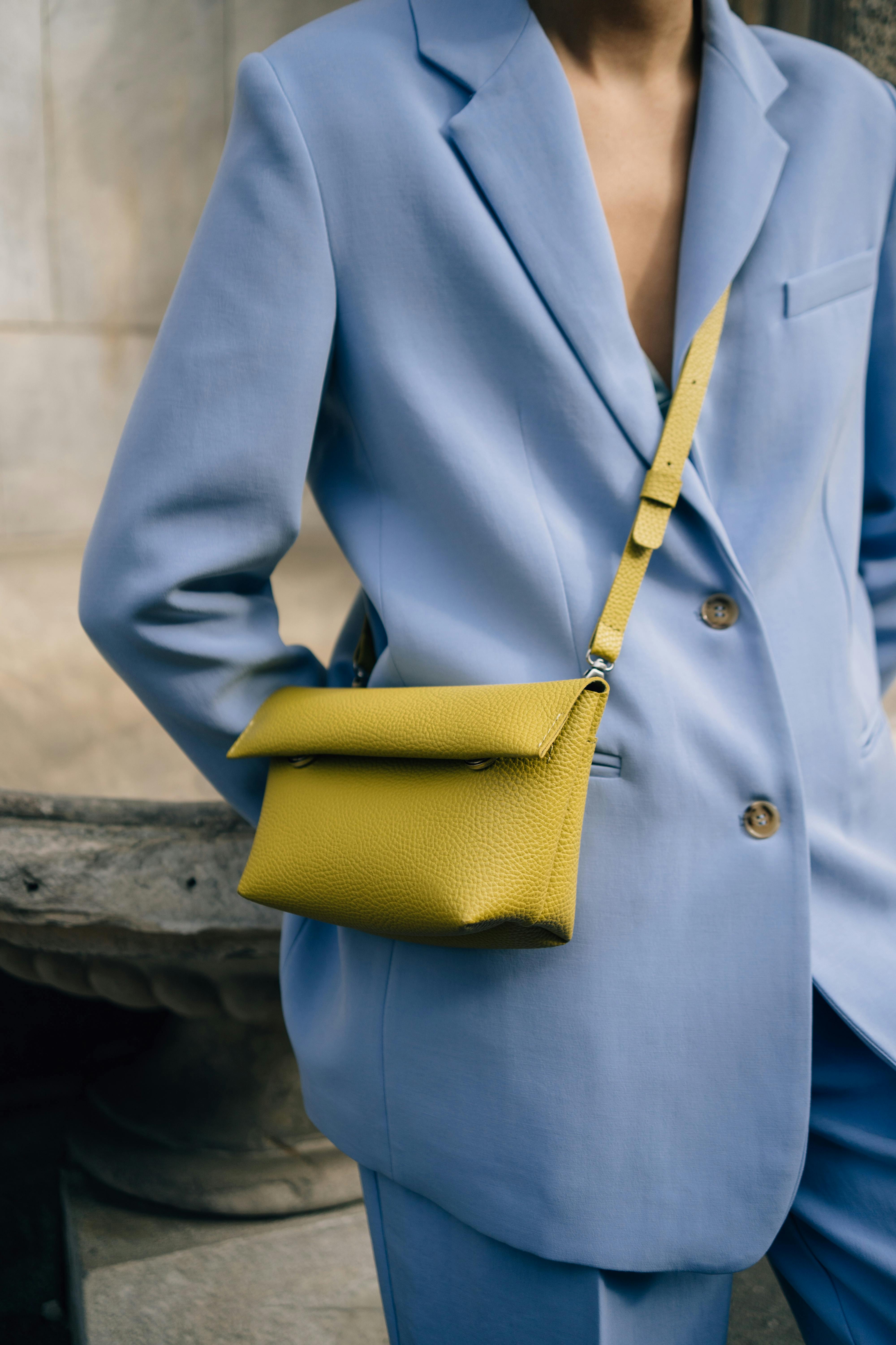 trendy blue trousers suit with the handbag