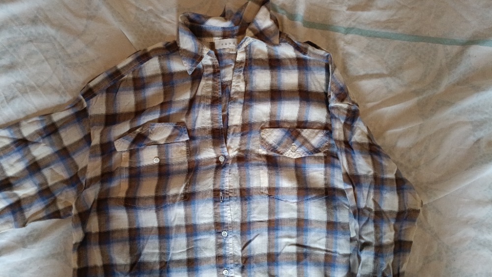 The plaid shirt buttoned up by Sandro